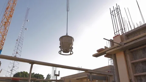 Concrete mixer lifting crane. Construction crane lifts the concrete mixer over Stock Footage 110771437