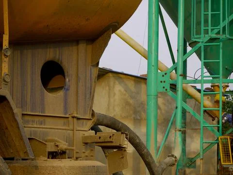 Concrete mixer machine with pipe connection presenting around sky industrial  스톡 사진