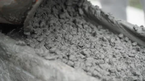 The concrete mixture flows down from the concrete mixer along the rail close-up Stock Footage 236922046