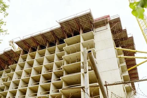 Concrete multi-level apartment block under construction with a massive tower Stock Photos