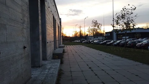 Concrete park in sunset light next to parking Stock Footage 122556272