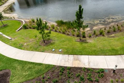 Concrete pathway alongside a lake Foto stock