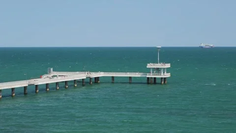 Concrete pier extending over turquoise seawater Stock Footage 344994299