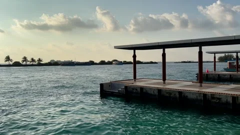 Concrete pier platform over ocean water with palm trees Maldives Stock Footage 334694338