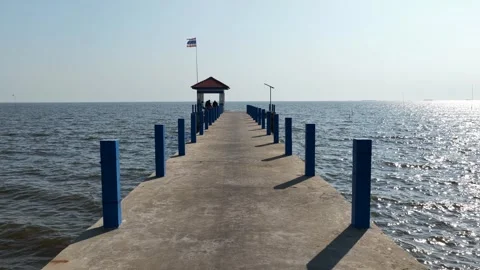 Concrete pier with thai flag extending into the sea Stock Footage 328489802