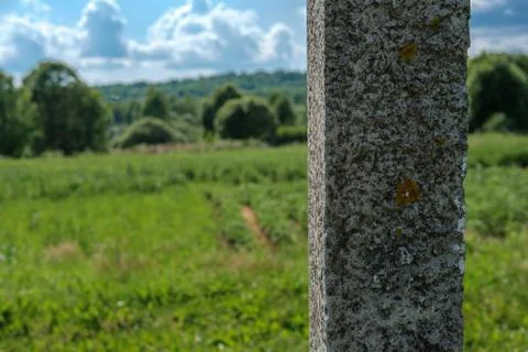 Concrete pillar on the background of the field. Stock Photos