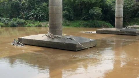 Concrete pillars of a bridge in a flooded river Stock Footage 321320441