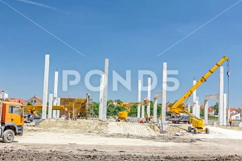 Concrete pillars of new edifice on sandy ground Stock Photos