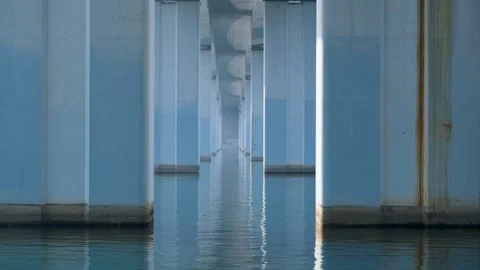 Concrete pillars or columns over flowing river under bridge. Vídeos de archivo 295253290