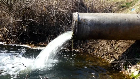 Concrete pipe transporting the poluted river Stock Footage 88308251