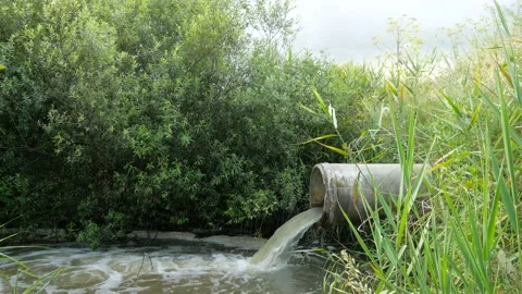 Concrete pipe transporting the smelly polluted sewage water Stock Footage 135700692