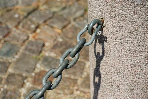 Concrete Post with Metal Hook and Attached Chain Stock Photos