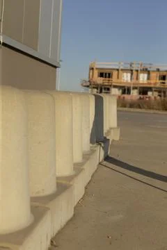 Concrete posts securely set to define construction perimeter under sunlight Stock Photos
