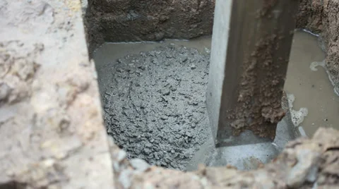 Concrete pouring to base of the pole for building a house Stock Footage 36890216