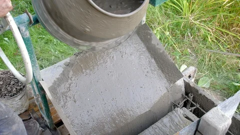 Concrete pouring. Construction worker mixing mortar. Pouring concrete mix from Stock Footage 95287837