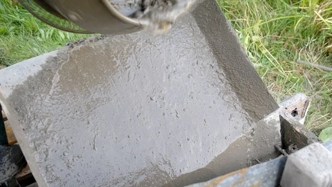 Concrete pouring. Construction worker mixing mortar. Pouring concrete mix from 動画素材 95288415