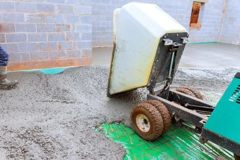 Concrete pouring process at construction site using mixer concrete buggy truck Stock Photos