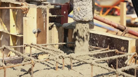 Concrete pouring into reinforced foundation formwork Stock Footage 341294781