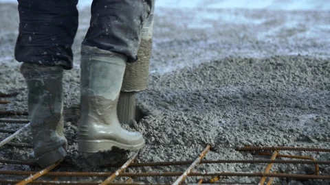 Concrete pours from the pipe into the foundation. Workers concrete the building Video stock 106279698