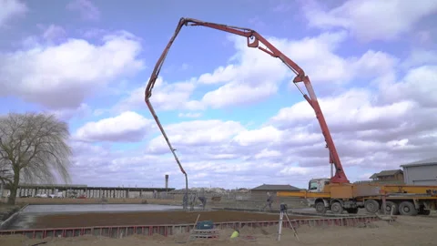 Concrete pours from the pipe into the foundation. Workers concrete the building Stock-Footage 148448979