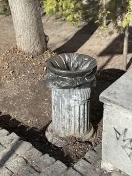 Concrete Public Trash Can with Plastic Bag on City Street Stock Photos