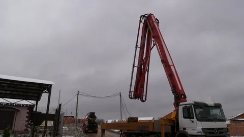 Concrete pump machine fold down boom after complete work and leave away. Stock Footage 83504360
