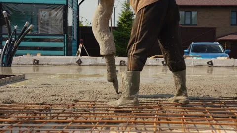 Concrete pump pouring wet cement on rebar mesh Stock Footage 341294468