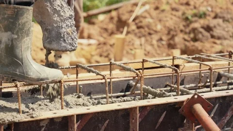 Concrete pump pouring wet cement into foundation formwork Stock Footage 341294795