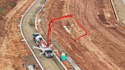 Concrete pumper working on path construction at new residential site Stock Footage 278300869