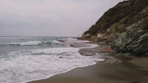 A concrete quay by a sandy beach Stock Footage 228875249