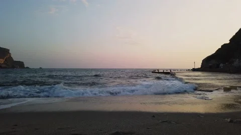 A concrete quay by a sandy beach Stock Footage 228875307