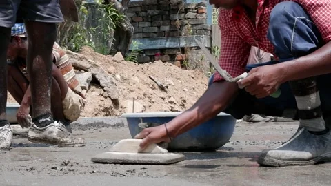 Concrete, RCC Road Casting by Indian Construction Labour Stock Footage 176765927
