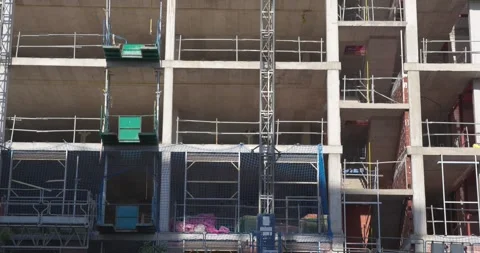 Concrete Residential Structure Under Construction with Scaffolding and Building Stock Footage 336012073