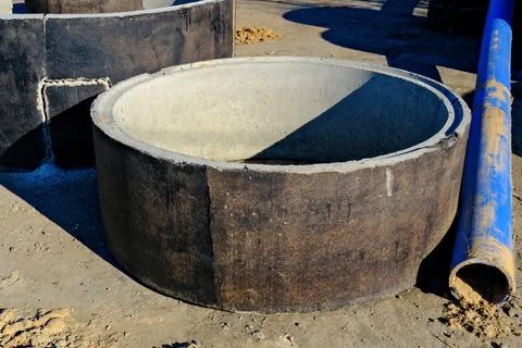 Concrete ring structure for well or sewer system placed on ground with plas.. Stockfoto's