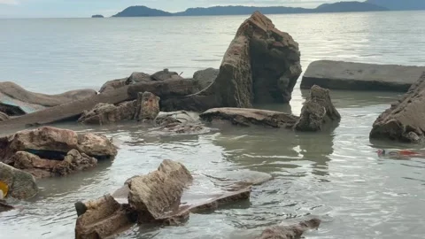 Concrete Rubble and Large Rocks on a Coastal Shoreline Stock Footage 330145490