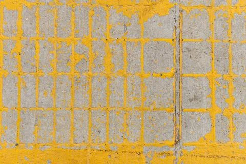 Concrete sidewalk with yellow grid pattern seen under natural light during .. Stock Photos