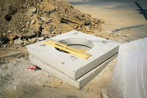 Concrete slab features a central circular opening designed for underground .. Stock-Fotos