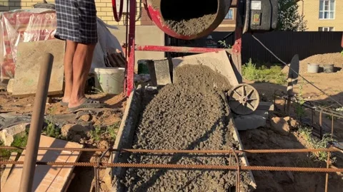 Concrete solution is poured out of the concrete mixer, Video stock 238810036
