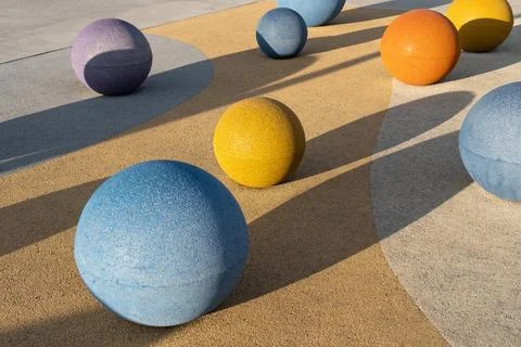Concrete spheres Colorful objects of different sizes rest on a textured sur.. Stock Photos