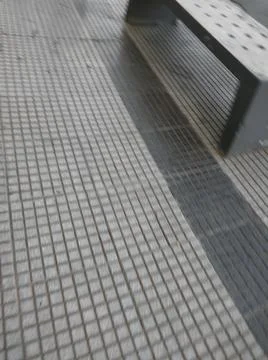 Concrete squared sidewalk background with different elements in street in day 库存照片
