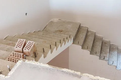 Concrete staircase under construction with exposed steps, unfinished wall, .. Stock Photos