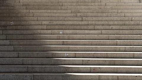Concrete steps where light falls on one side, creating a light-and-shadow e.. Stock Photos