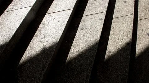 Concrete steps where light falls on one side, creating a light-and-shadow e.. Stock Photos