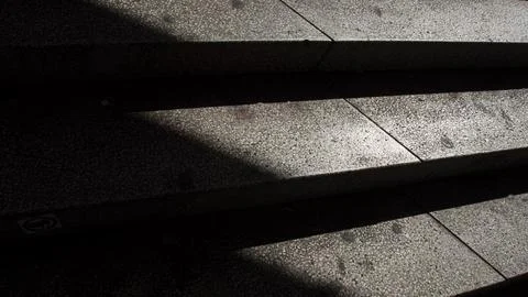 Concrete steps where light falls on one side, creating a light-and-shadow e.. Stock Photos