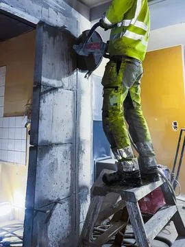 Concrete structure cutting using construction equipment. Stock Photos