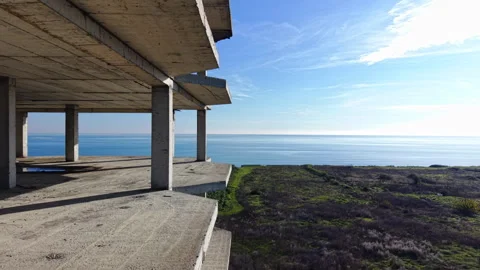 Concrete structure of unfinished building overlooking the sea Video stock 327927680