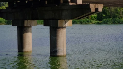 Concrete supports of a bridge over river. View from under the bridge. Video stock 112976728