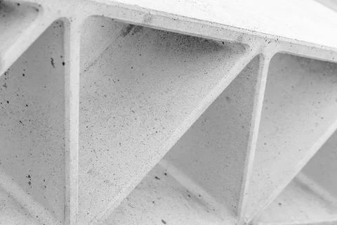 Concrete surface featuring repeating triangular voids Stock Photos