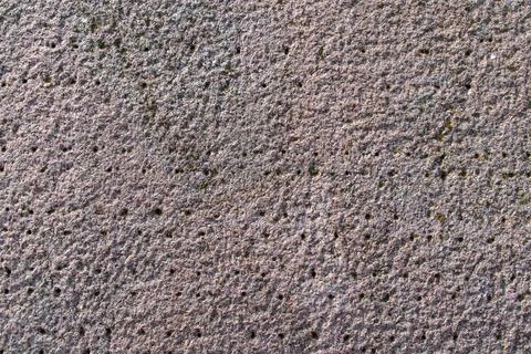 Concrete surface featuring rough pitted texture on pavement Stock Photos