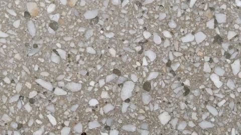 Concrete surface with multi-colored blotches of small stones. Light beige ton Foto stock
